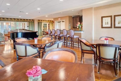 Bright common area with seating and piano