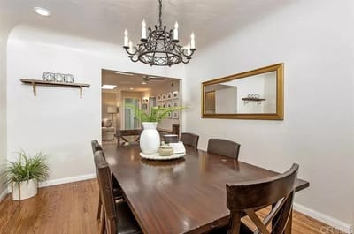 Dining area with a wooden table and chandelier