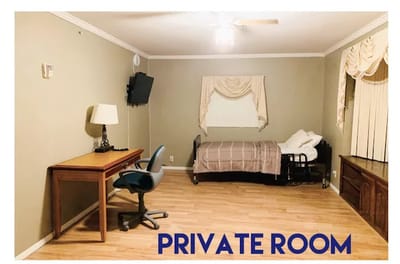 A private room with a bed and desk in the facility