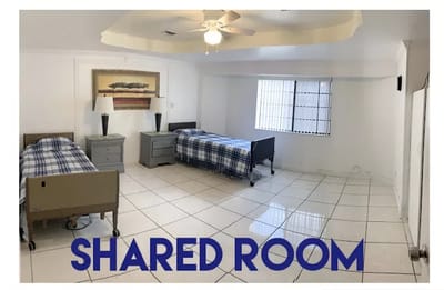 Bright shared room with two beds and nightstands