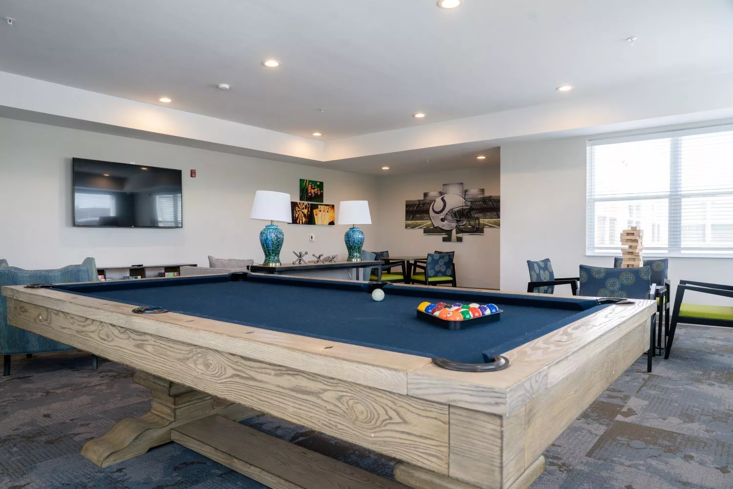 Interior view of a recreational common area with a pool table