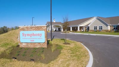 Exterior view of Symphony Assisted Living building with sign