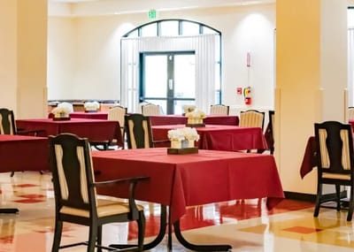 Dining area with red tablecloths and flowers
