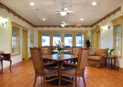 Bright common area with seating and floral arrangement