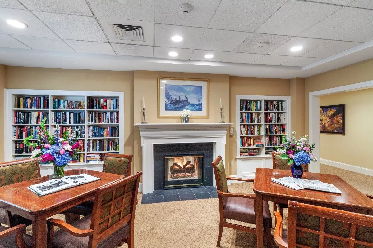 Cozy common area with bookshelves and fireplace