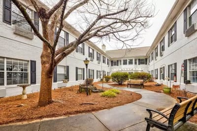 Outdoor courtyard with benches and landscaping.
