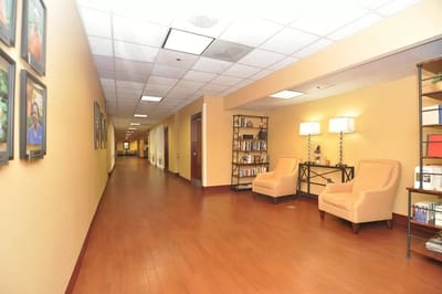 A hallway in a senior living facility with seating