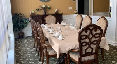 Dining room set for a meal with elegant table settings