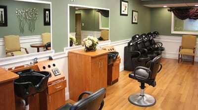 Beauty salon area with styling stations and chairs