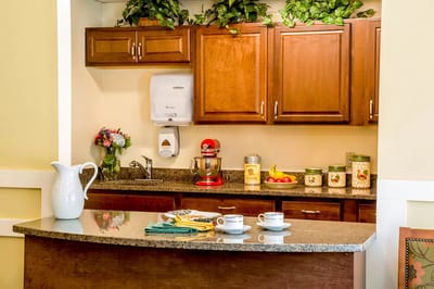 Bright kitchen area with cabinets and decor