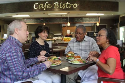 Residents enjoying meals together in a dining area