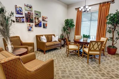 Comfortable seating area with plants and artwork