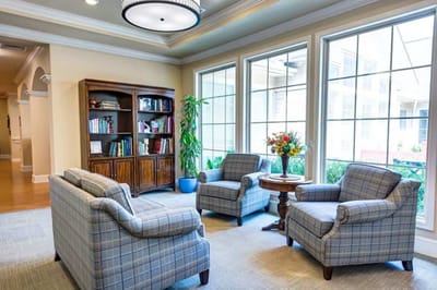 Cozy lounge area with armchairs and bookshelf