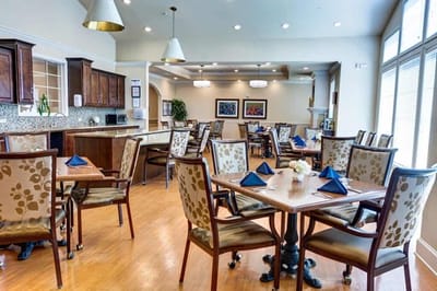 Dining area with tables and chairs set for a meal