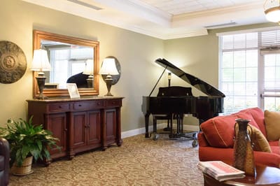 Interior of a common area with a piano and seating
