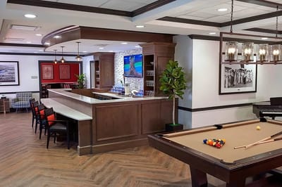 Interior common area with bar and pool table
