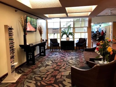 Interior view of a common area with seating and flowers