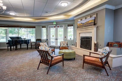 Common area seating with piano in a senior living facility