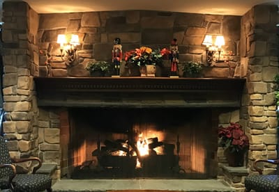 Warm indoor fireplace with decorations and flowers