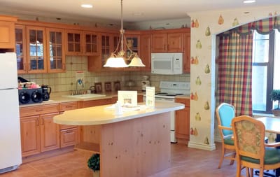 Bright kitchen space with wooden cabinets and seating area
