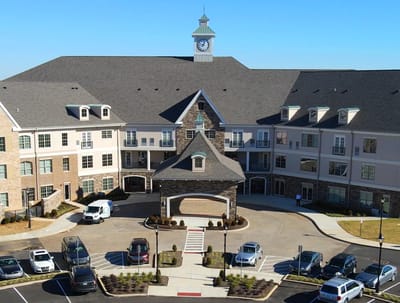 Aerial view of the facility entrance with clock tower and parking