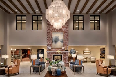 Modern interior lobby with ample seating and chandelier