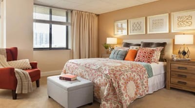 A well-furnished private bedroom in a senior living facility