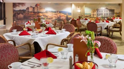 Dining area with decorated tables and food service setup