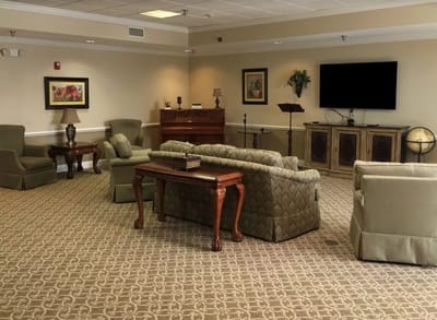 Common area with seating and piano in a senior living facility