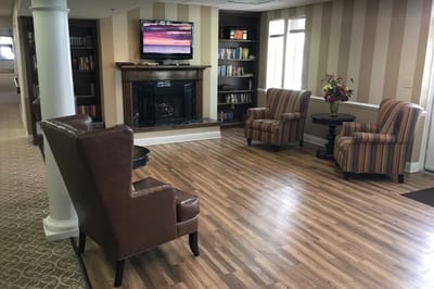 Interior common area with seating and bookshelf