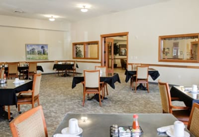 Interior view of a dining room with tables set