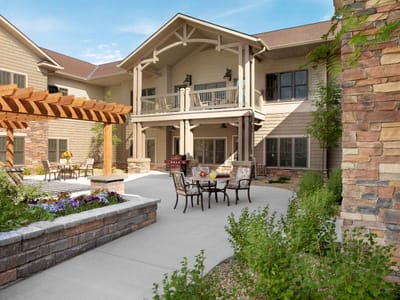 Outdoor seating area with tables and flower beds