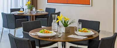 Dining area set up with meals and flowers