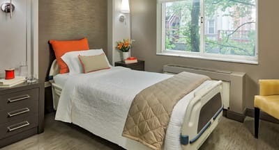 Bright and welcoming resident room with bed and decor