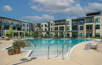 Outdoor pool area with building in background