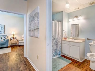 Brightly lit bathroom and sitting area in a resident unit