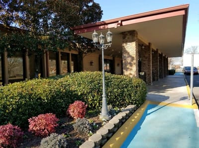 Entrance view of a senior living facility with landscaping