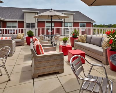 Outdoor seating area with comfortable furniture and umbrellas