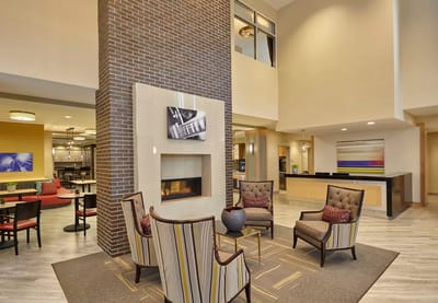 Bright and inviting common area with seating and fireplace