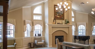 Bright common area with a fireplace and windows