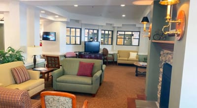 Interior common area with seating and a fireplace