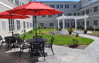Outdoor courtyard with seating and red umbrellas