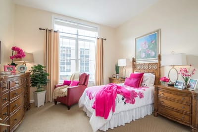 Brightly decorated private resident room with floral accents