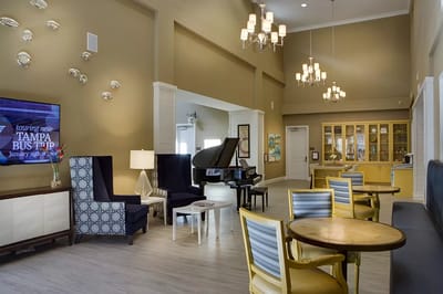 Bright common area with seating and a piano