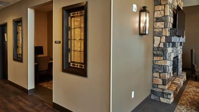 Interior view of a hallway with stone fireplace
