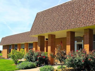 Exterior view of a senior living facility with landscaping