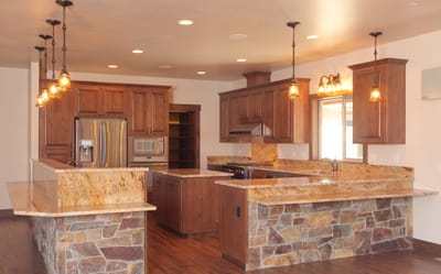Modern kitchen with granite countertops and wooden cabinetry