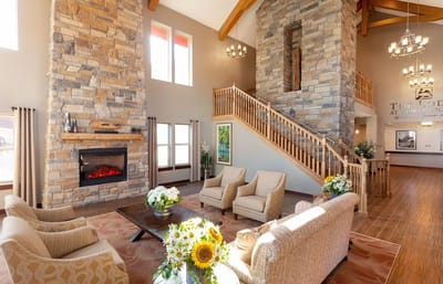 Bright and spacious lobby with a stone fireplace and seating