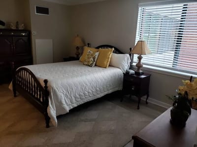 Cozy resident room with a bed and bedside lamps