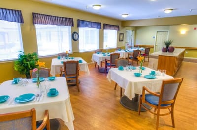 Bright dining area with tables and chairs set for meals